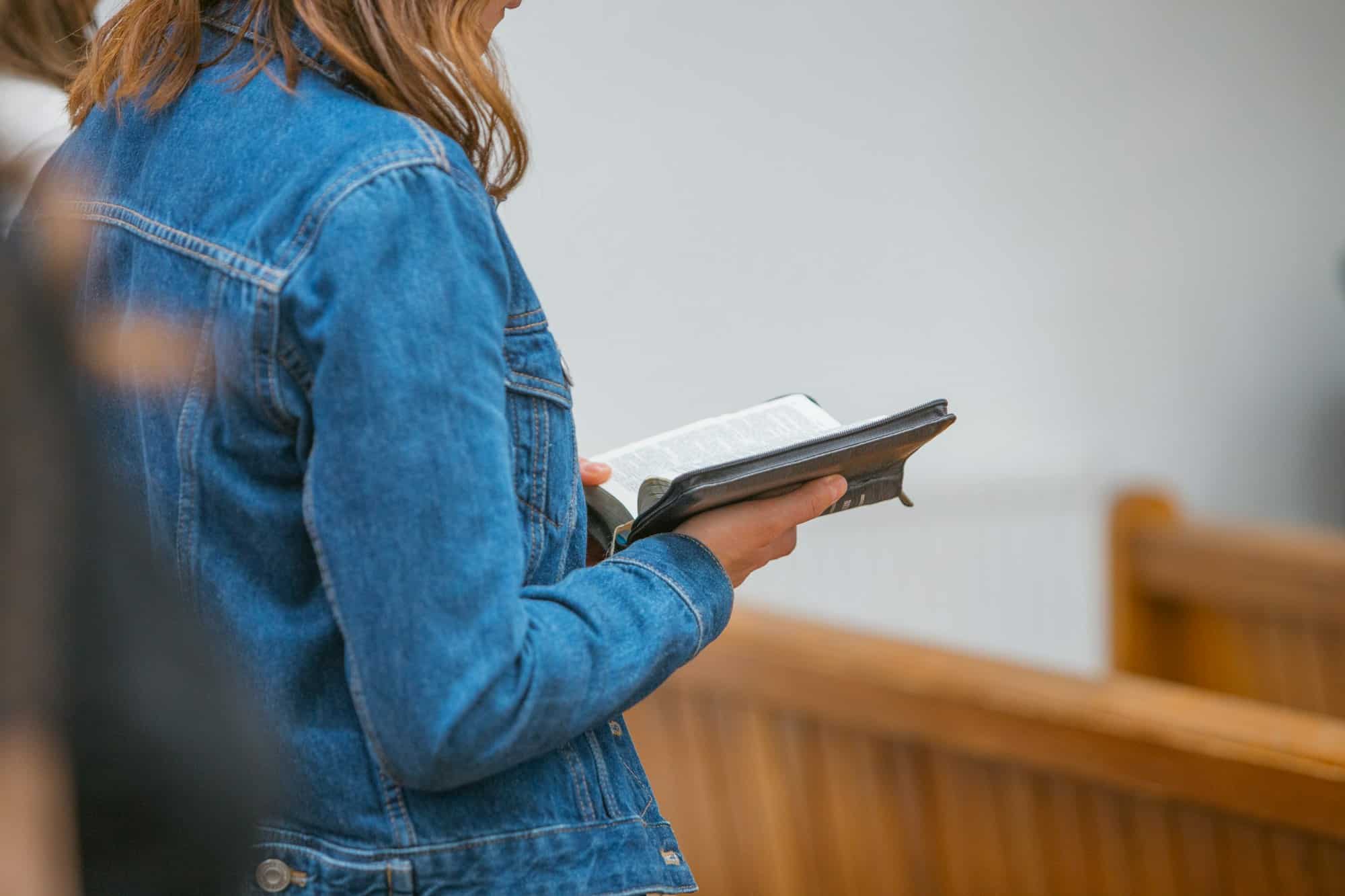 Woman holding a Bible and reading