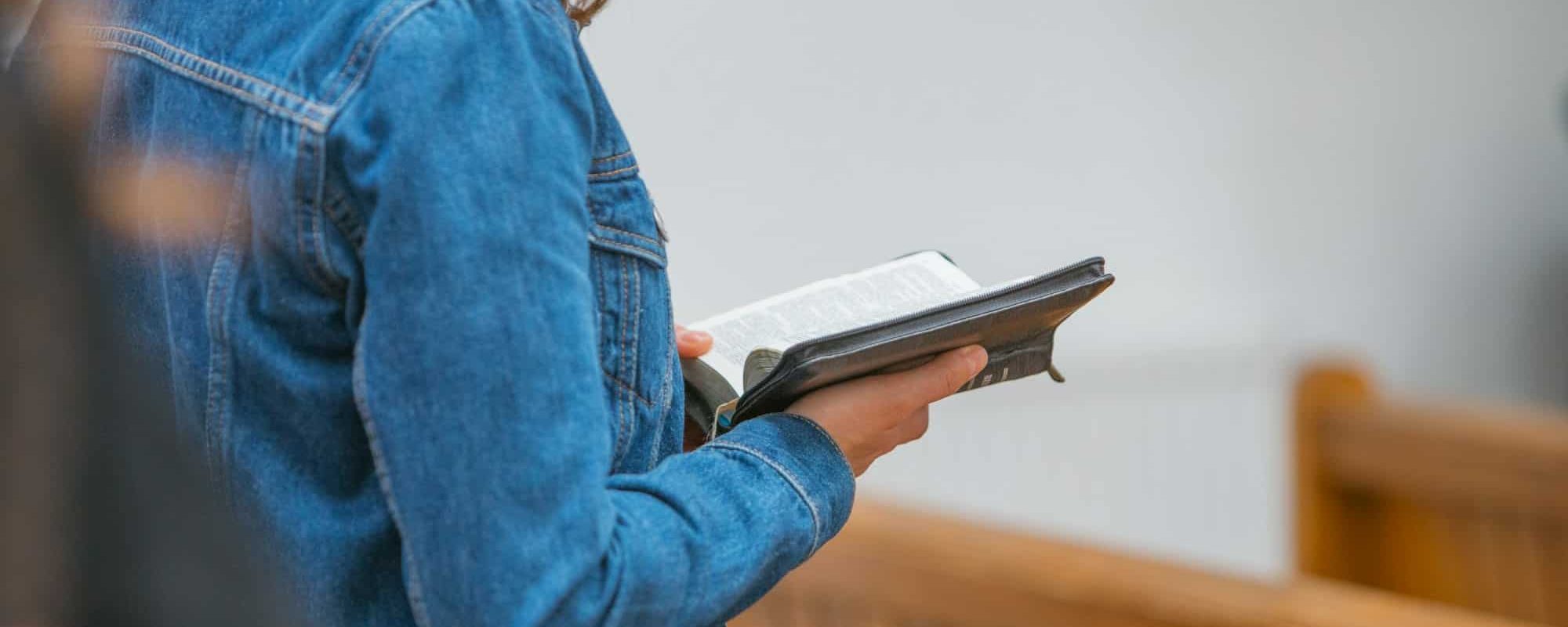 Woman holding a Bible and reading